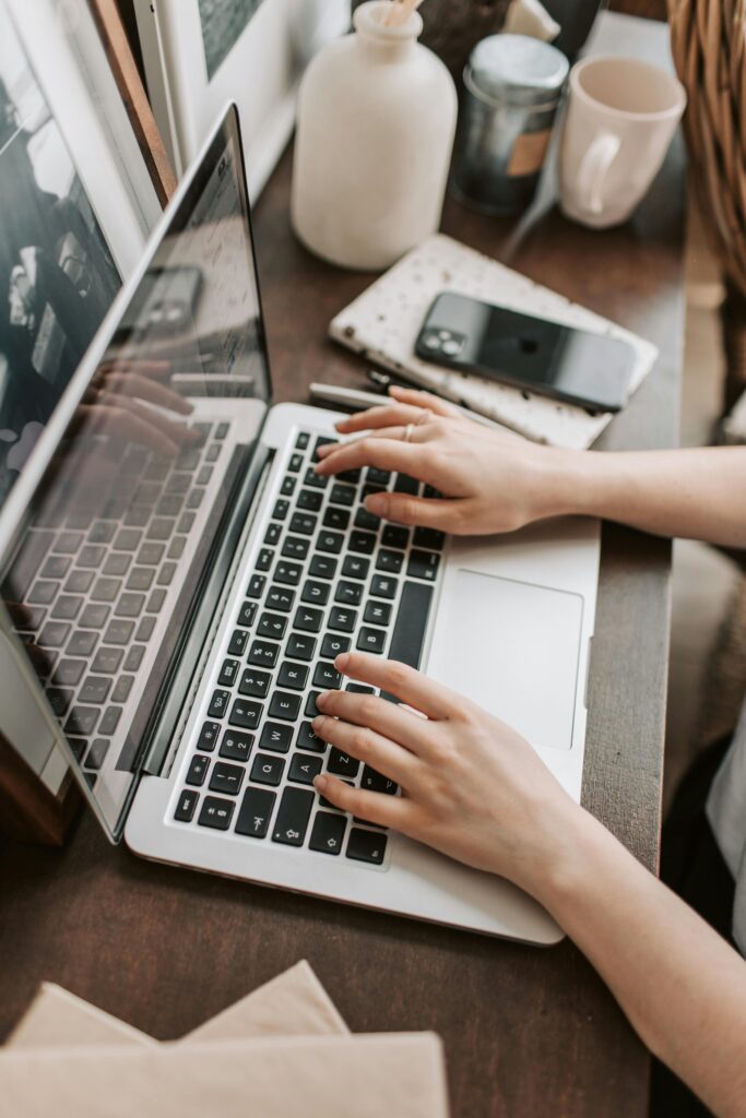 pexels-photo-4050312-4050312 From above of unrecognizable woman sitting at table and typing on keyboard of computer during remote work in modern workspace